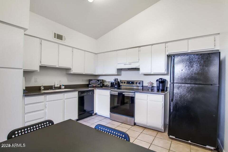 525 North May, Unit 10 Mesa, AZ 85201 - Photo 6 of 21 a kitchen with stainless steel appliances granite countertop a stove a refrigerator and a sink