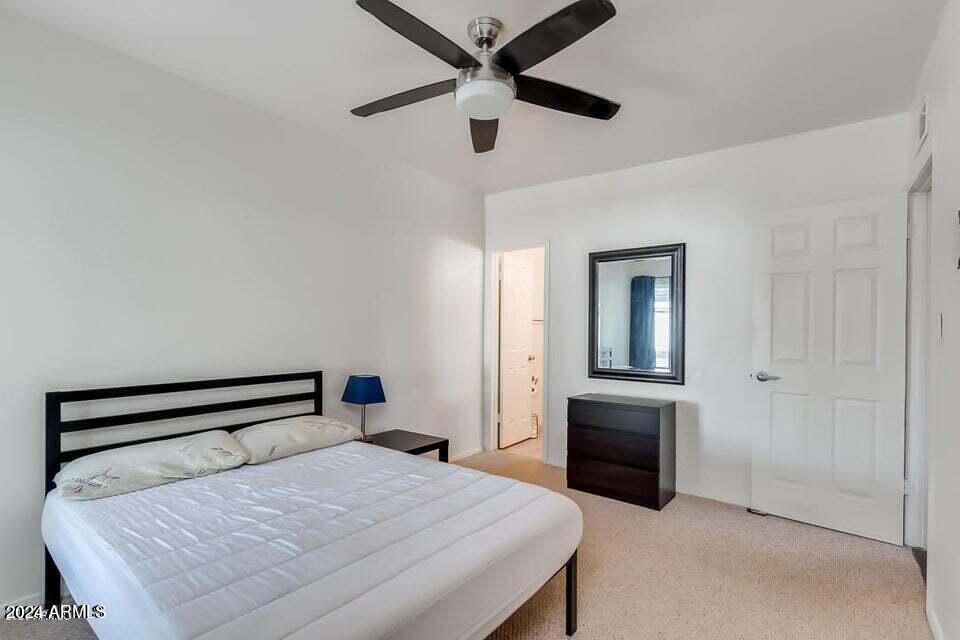 525 North May, Unit 10 Mesa, AZ 85201 - Photo 8 of 21 a bedroom with a bed and a chandelier