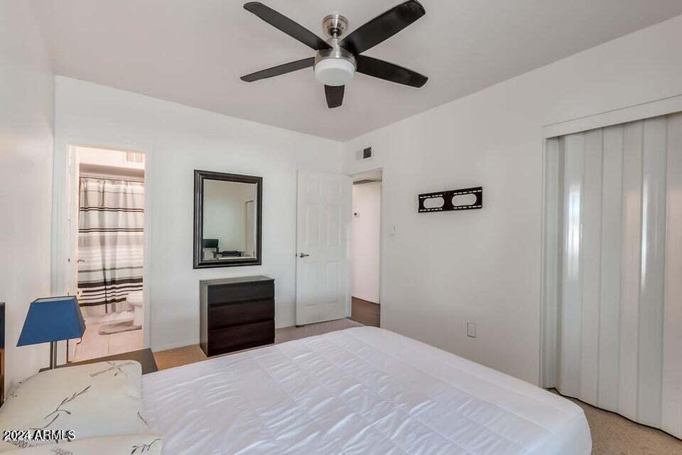 525 North May, Unit 10 Mesa, AZ 85201 - Photo 9 of 21 a bedroom with a bed and a chandelier