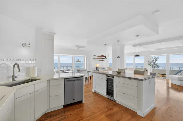 a kitchen with stainless steel appliances granite countertop a sink and a refrigerator