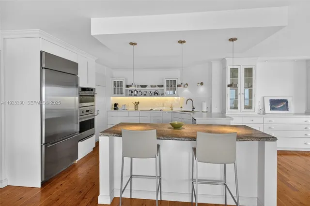 a dining room with furniture window and wooden floor