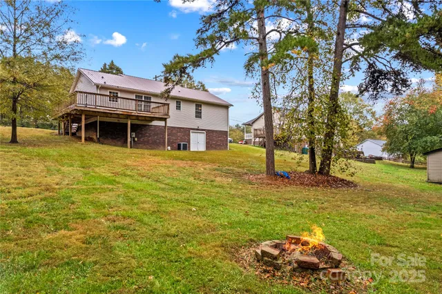 a view of a house with a yard and sitting area