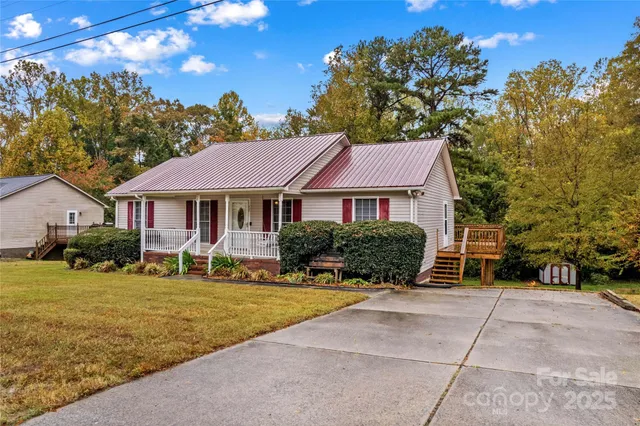 a front view of a house with yard porch and outdoor seating