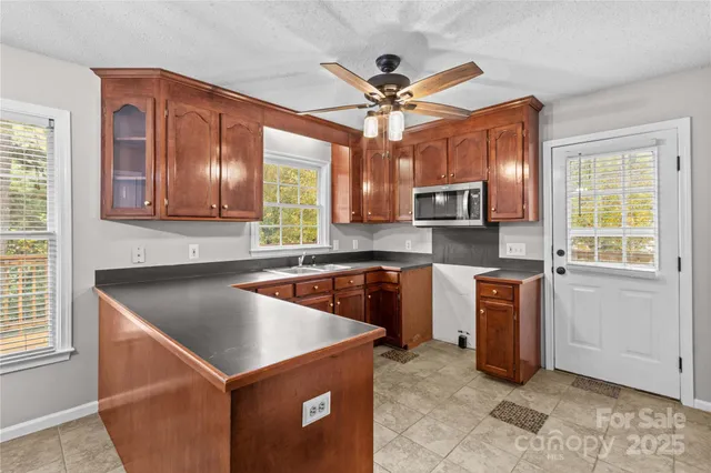 a kitchen that has a sink cabinets stainless steel appliances and a window