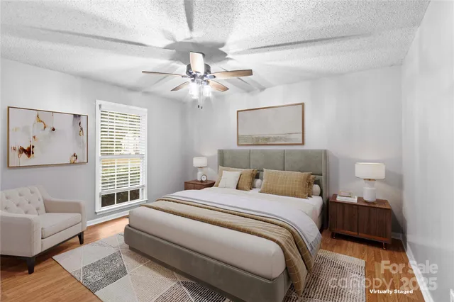 a bedroom with a large bed couch and a window