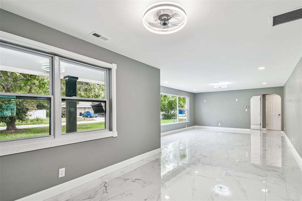 6016 Arthur Avenue New Port Richey, FL 34653 - Photo 13 of 33 a view of a livingroom with wooden floor and a large window