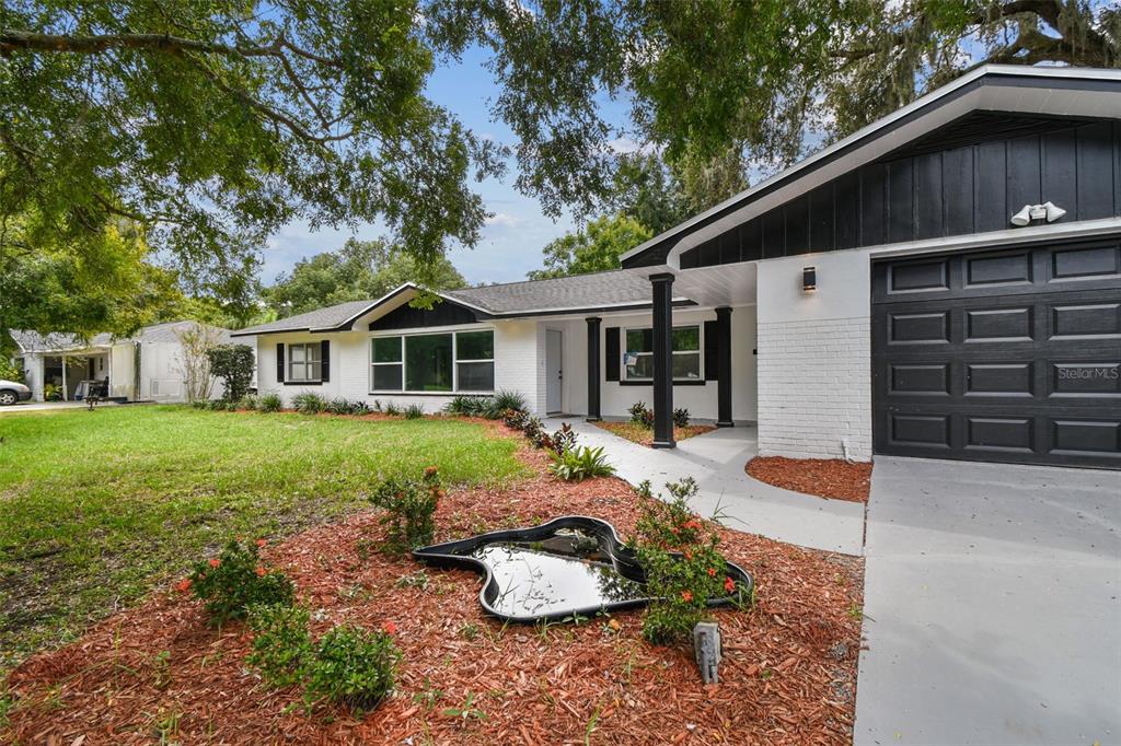 6016 Arthur Avenue New Port Richey, FL 34653 - Photo 2 of 33 a front view of a house with a yard and garage