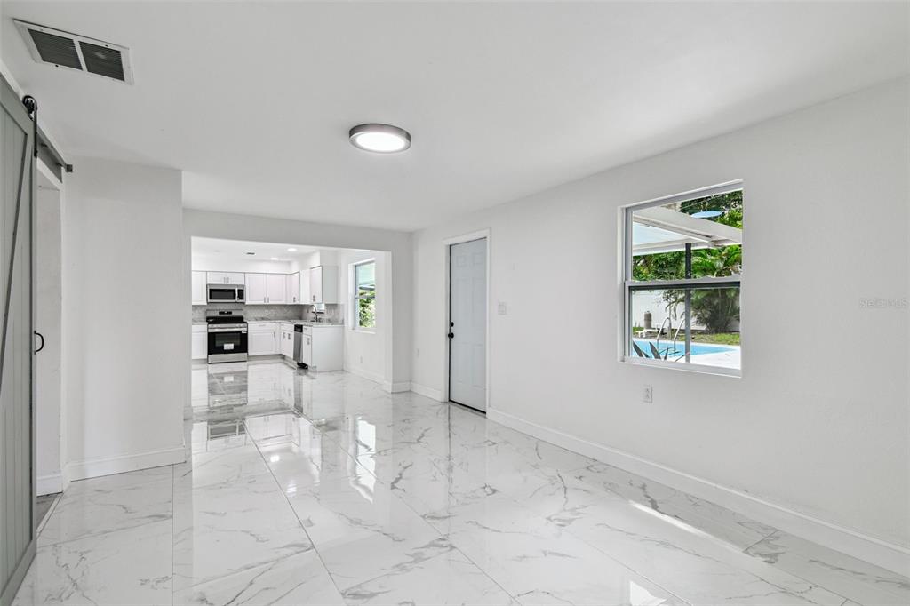 6016 Arthur Avenue New Port Richey, FL 34653 - Photo 24 of 33 a view of a kitchen with wooden floor and a window