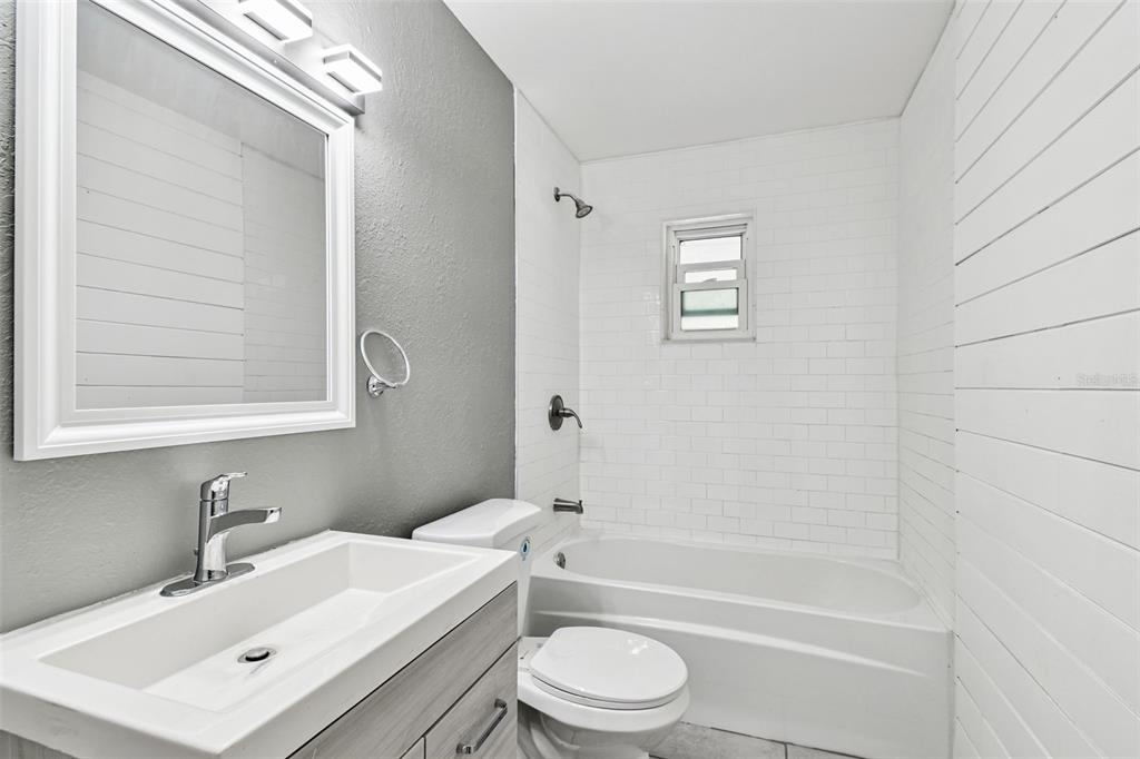 6016 Arthur Avenue New Port Richey, FL 34653 - Photo 27 of 33 a bathroom with a sink toilet a mirror and shower