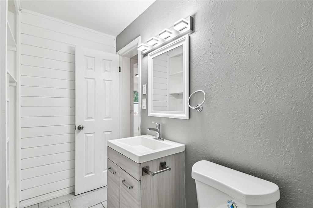 6016 Arthur Avenue New Port Richey, FL 34653 - Photo 28 of 33 a bathroom with a toilet a sink and mirror