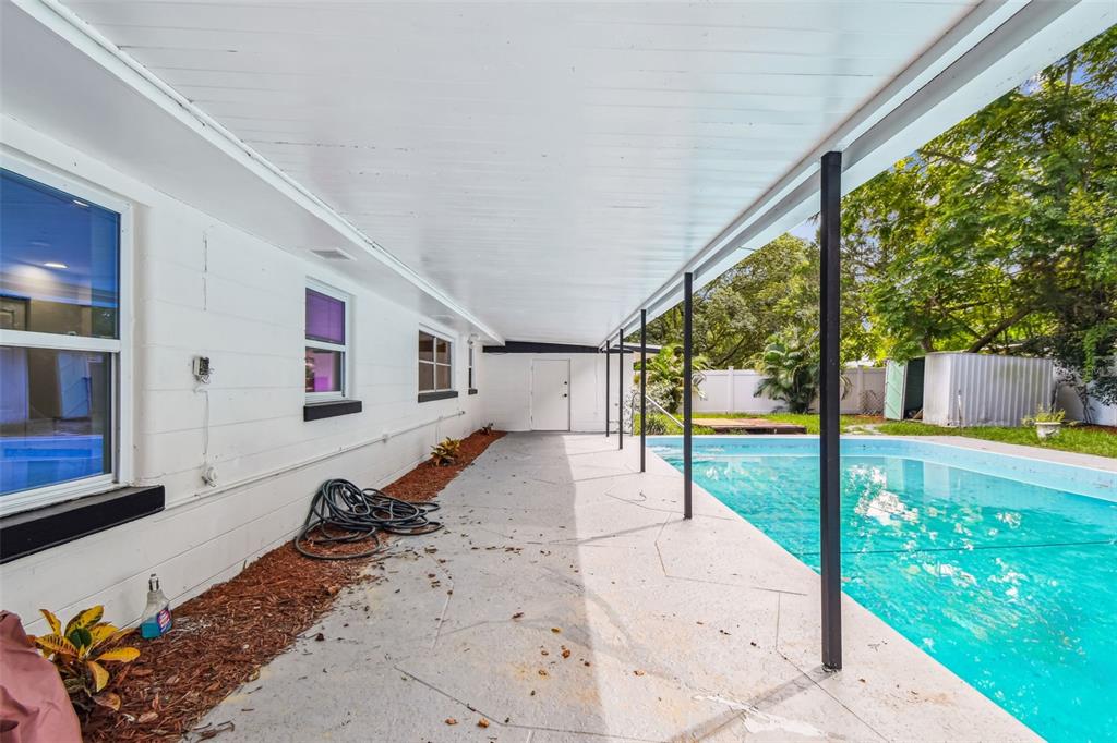 6016 Arthur Avenue New Port Richey, FL 34653 - Photo 29 of 33 a swimming pool with potted plants and wooden fence
