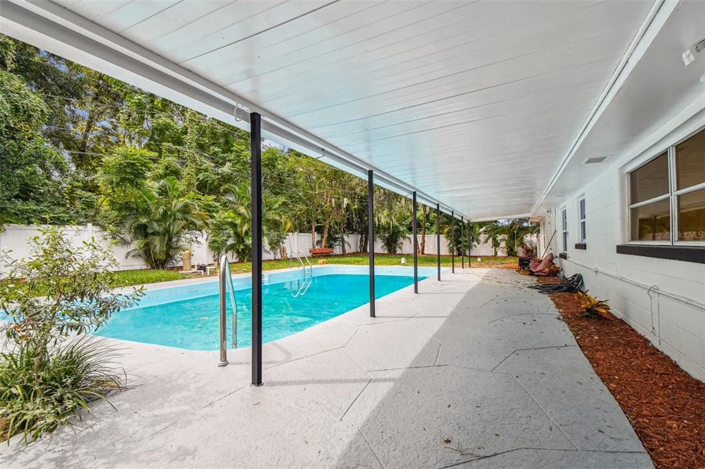 6016 Arthur Avenue New Port Richey, FL 34653 - Photo 30 of 33 a view of swimming pool with an outdoor seating