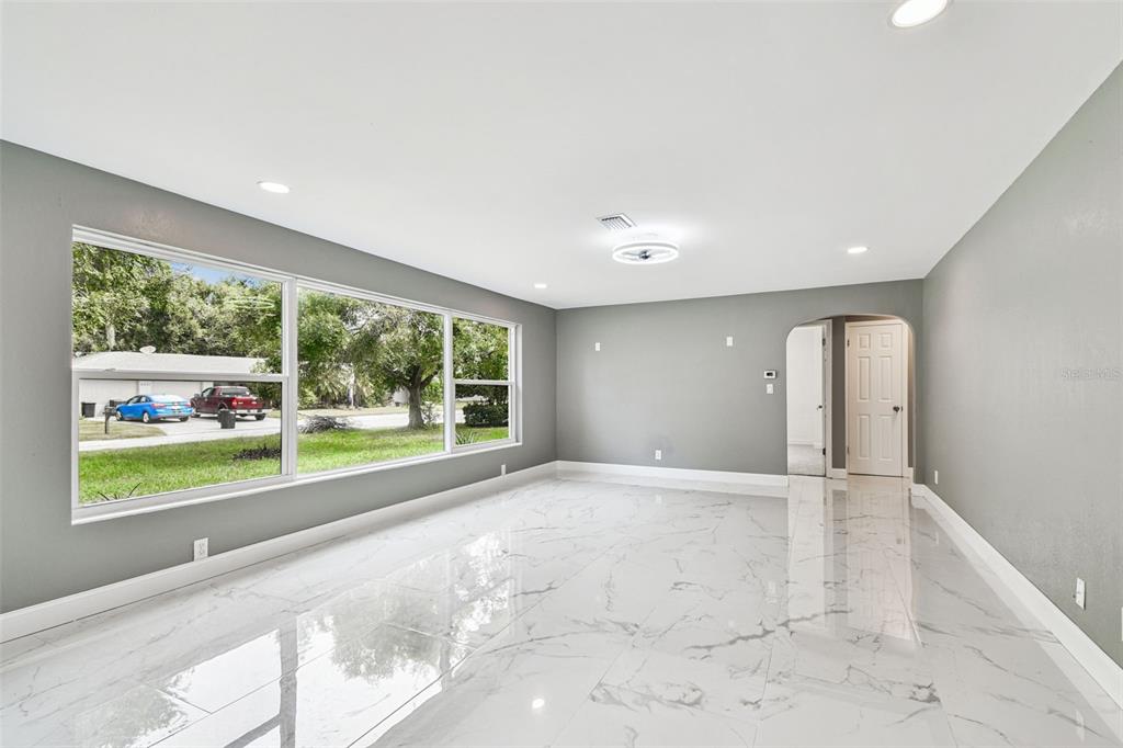 6016 Arthur Avenue New Port Richey, FL 34653 - Photo 5 of 33 a view of an empty room with a window and a swimming pool