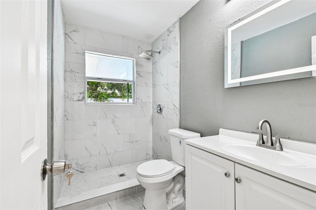 6016 Arthur Avenue New Port Richey, FL 34653 - Photo 8 of 33 a bathroom with a sink toilet and shower