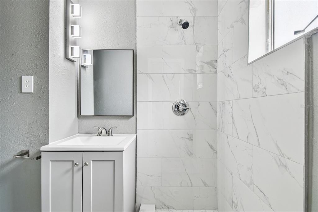 6016 Arthur Avenue New Port Richey, FL 34653 - Photo 10 of 33 a bathroom with a sink vanity and a mirror