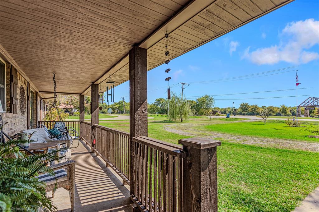 a view of a porch with furniture and garden