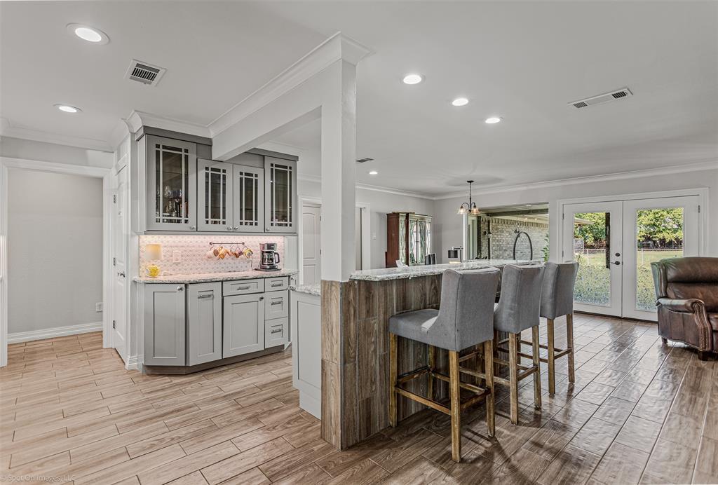 3713 Hickox Road Rowlett, TX 75089 - Photo 10 of 36 a kitchen with a dining table chairs cabinets and stainless steel appliances