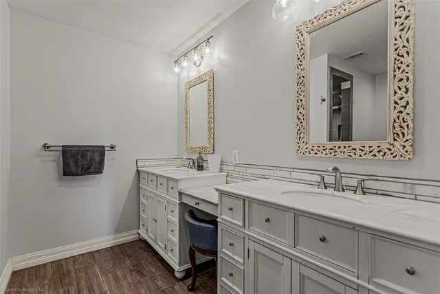 a bedroom with furniture and wooden floor