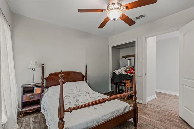 a large kitchen with stainless steel appliances granite countertop a stove and a wooden floors