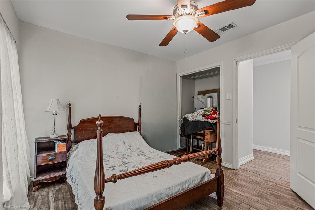 3713 Hickox Road Rowlett, TX 75089 - Photo 19 of 39 a bedroom with a bed and wooden floor