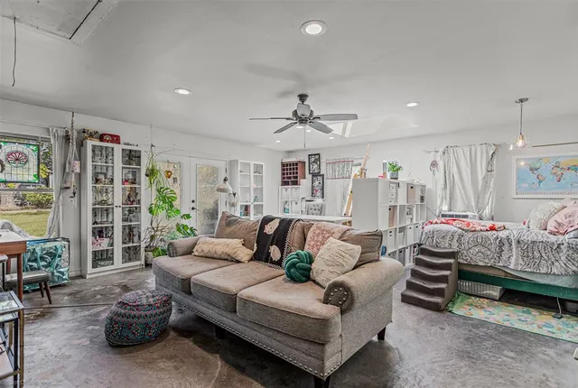 a bedroom with a bed a dresser and book shelf