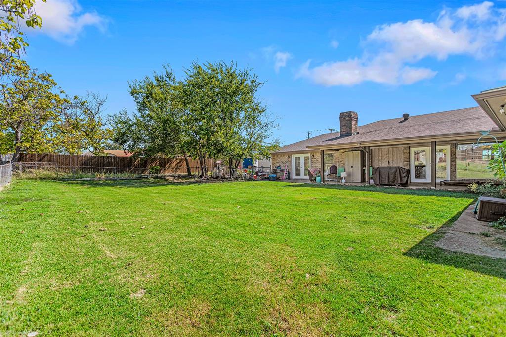 3713 Hickox Road Rowlett, TX 75089 - Photo 25 of 39 a view of house that has a yard