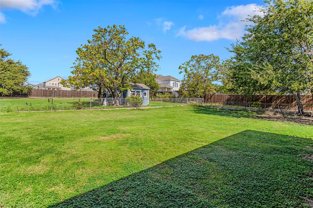 3713 Hickox Road Rowlett, TX 75089 - Photo 26 of 36 a view of a grassy field with trees