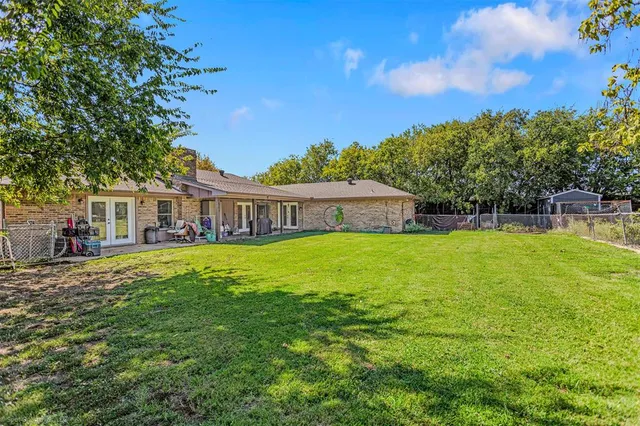 a view of house that has a yard