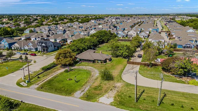 an aerial view of residential houses with outdoor space and street view
