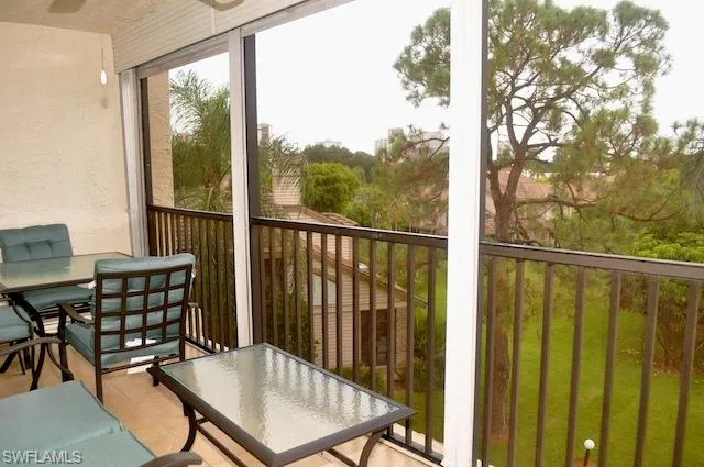 a balcony with table and chairs