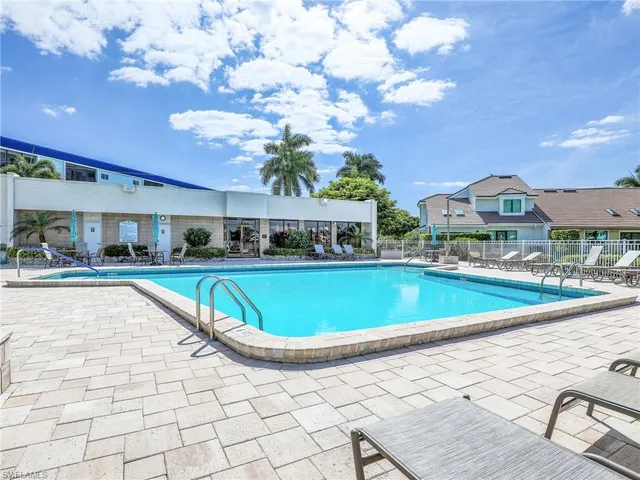 a view of an house with swimming pool and sitting area