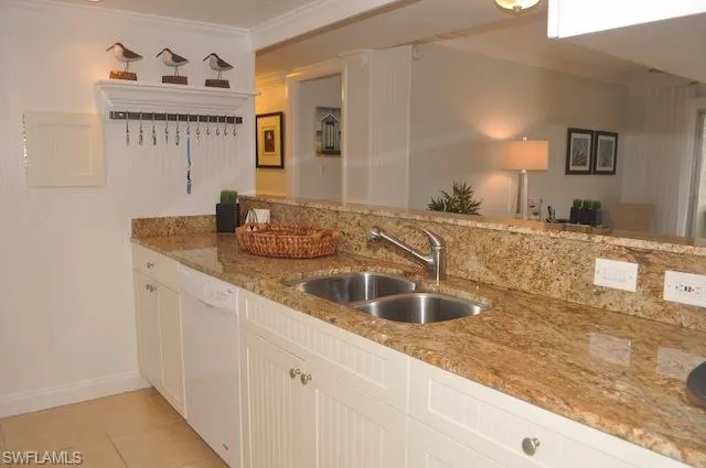 a kitchen with granite countertop a sink and a wooden floor