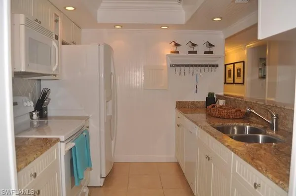 a kitchen with a sink stove and refrigerator