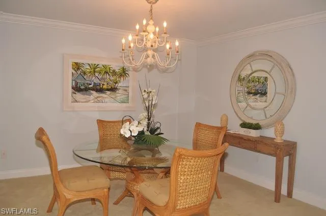 a dining room with furniture and chandelier