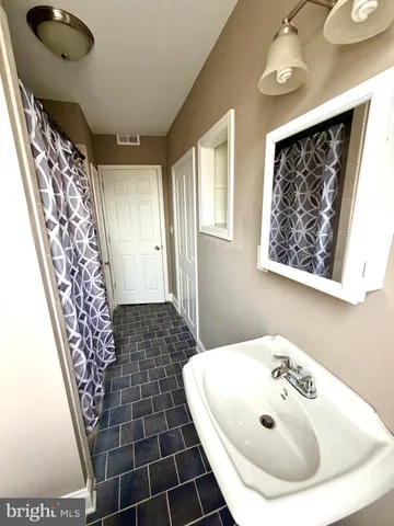 a bathroom with a sink a mirror and a shower