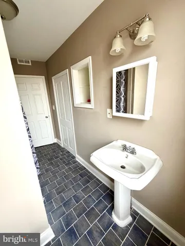 a bathroom with a bathtub and shower
