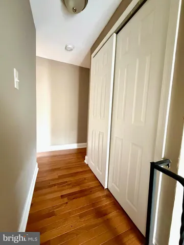 a view of an empty room with kitchen