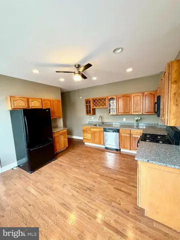 a view of a kitchen with stainless steel appliances a stove and a refrigerator