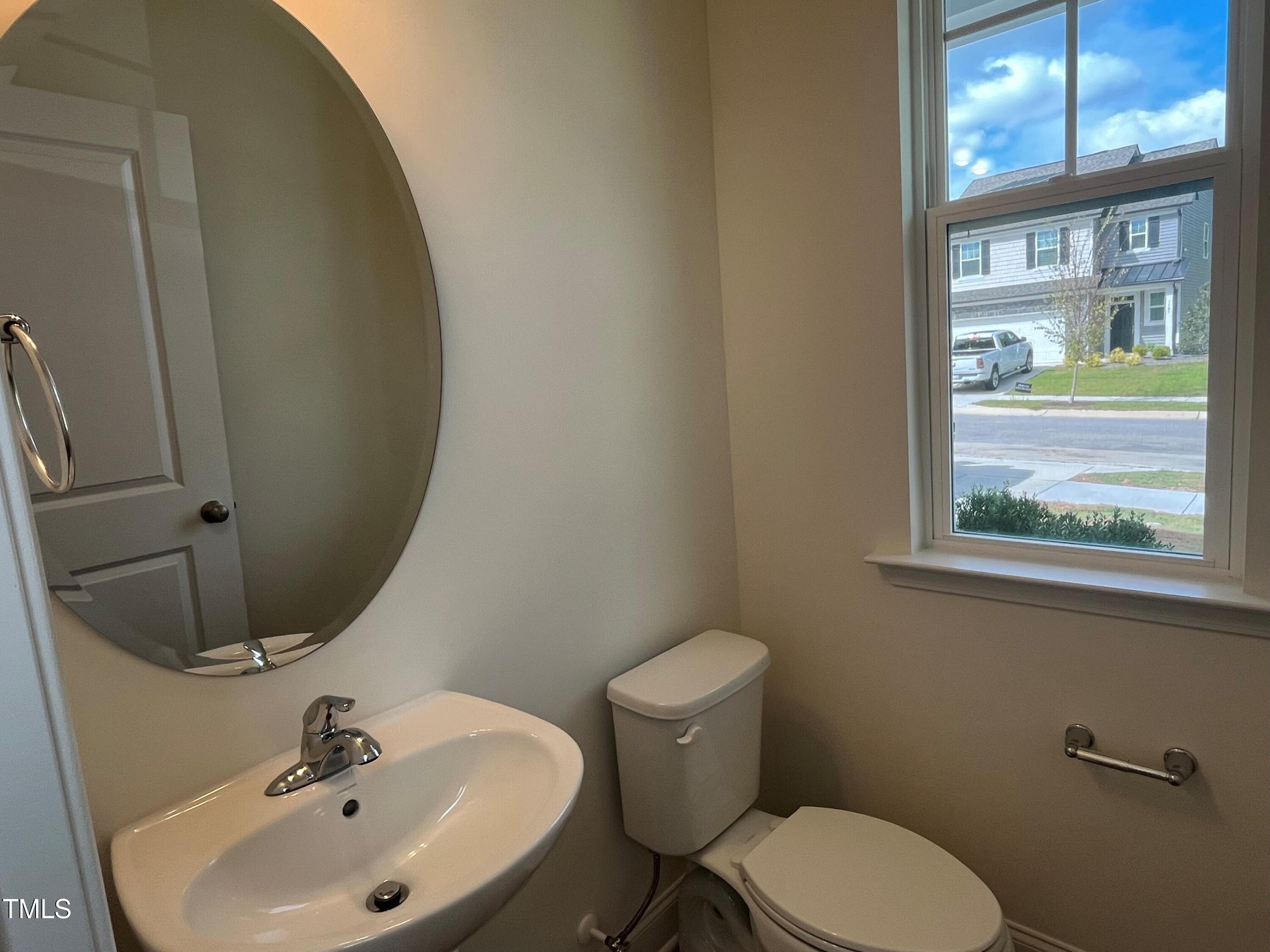 5108 River Sand Trail Raleigh, NC 27604 - Photo 12 of 59 a white toilet sitting next to a bathroom sink