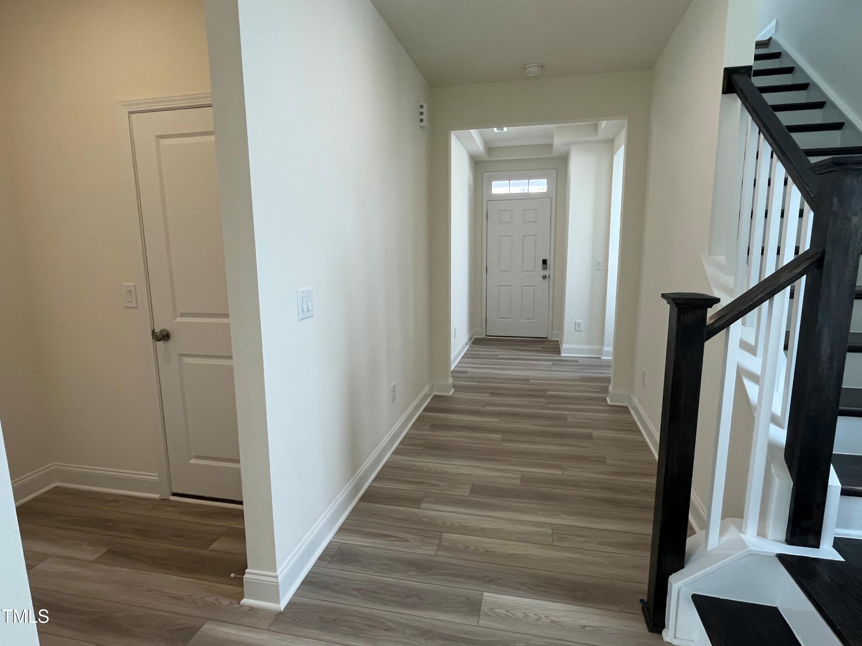 5108 River Sand Trail Raleigh, NC 27604 - Photo 14 of 59 a view of a hallway with wooden floor and staircase