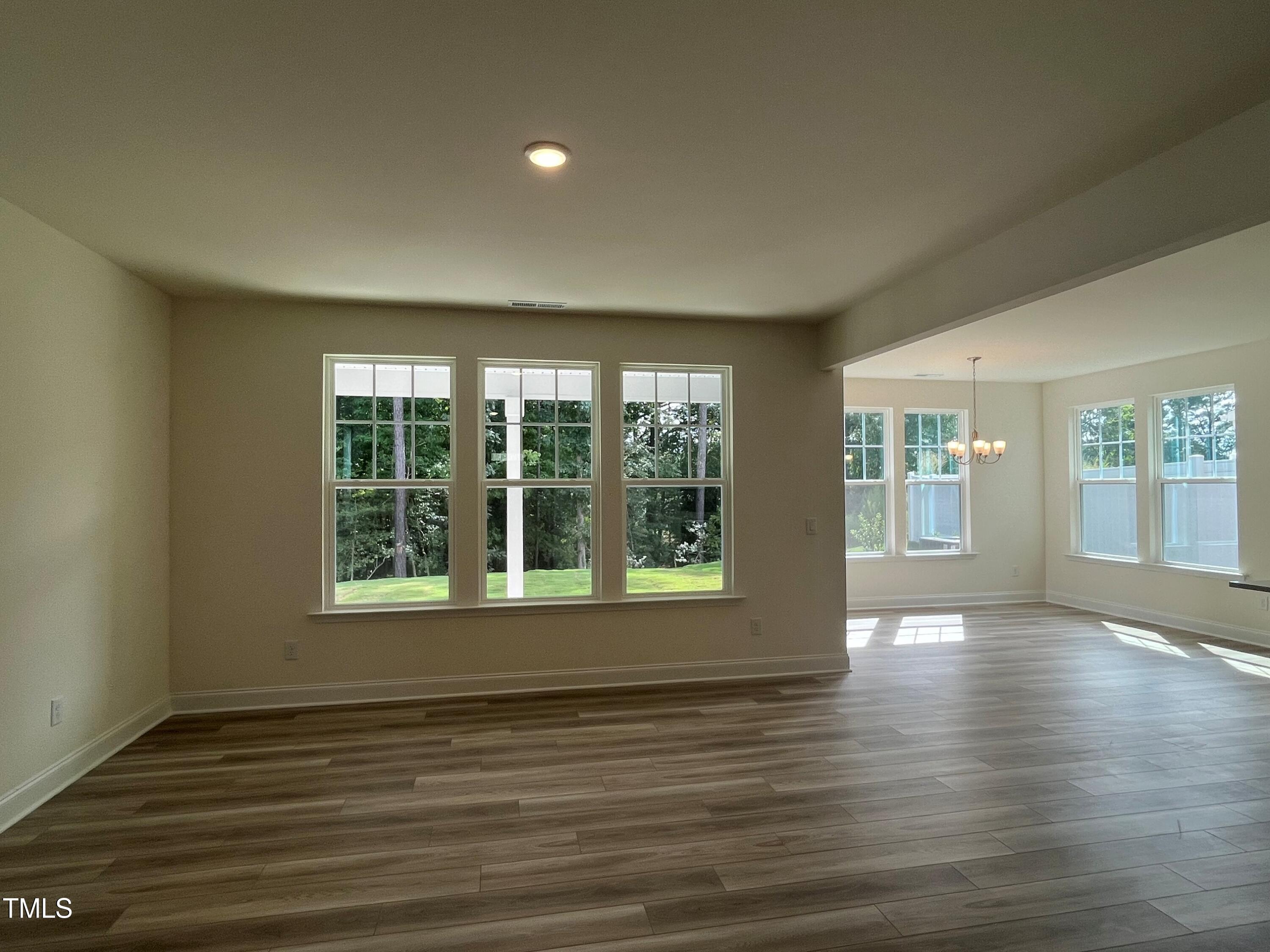 5108 River Sand Trail Raleigh, NC 27604 - Photo 15 of 59 a view of an empty room with wooden floor and a window