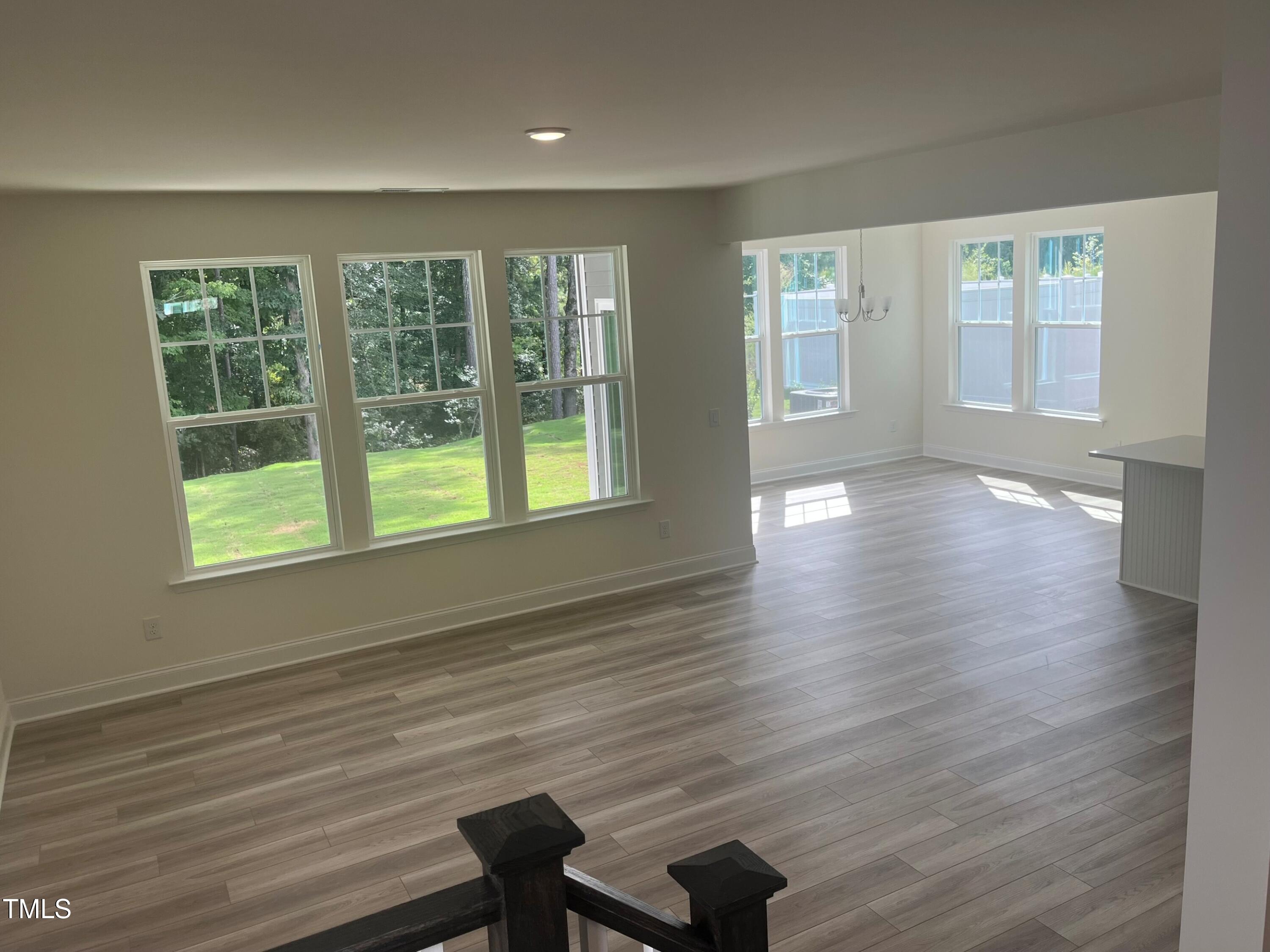 5108 River Sand Trail Raleigh, NC 27604 - Photo 23 of 59 a view of an empty room with wooden floor and a window