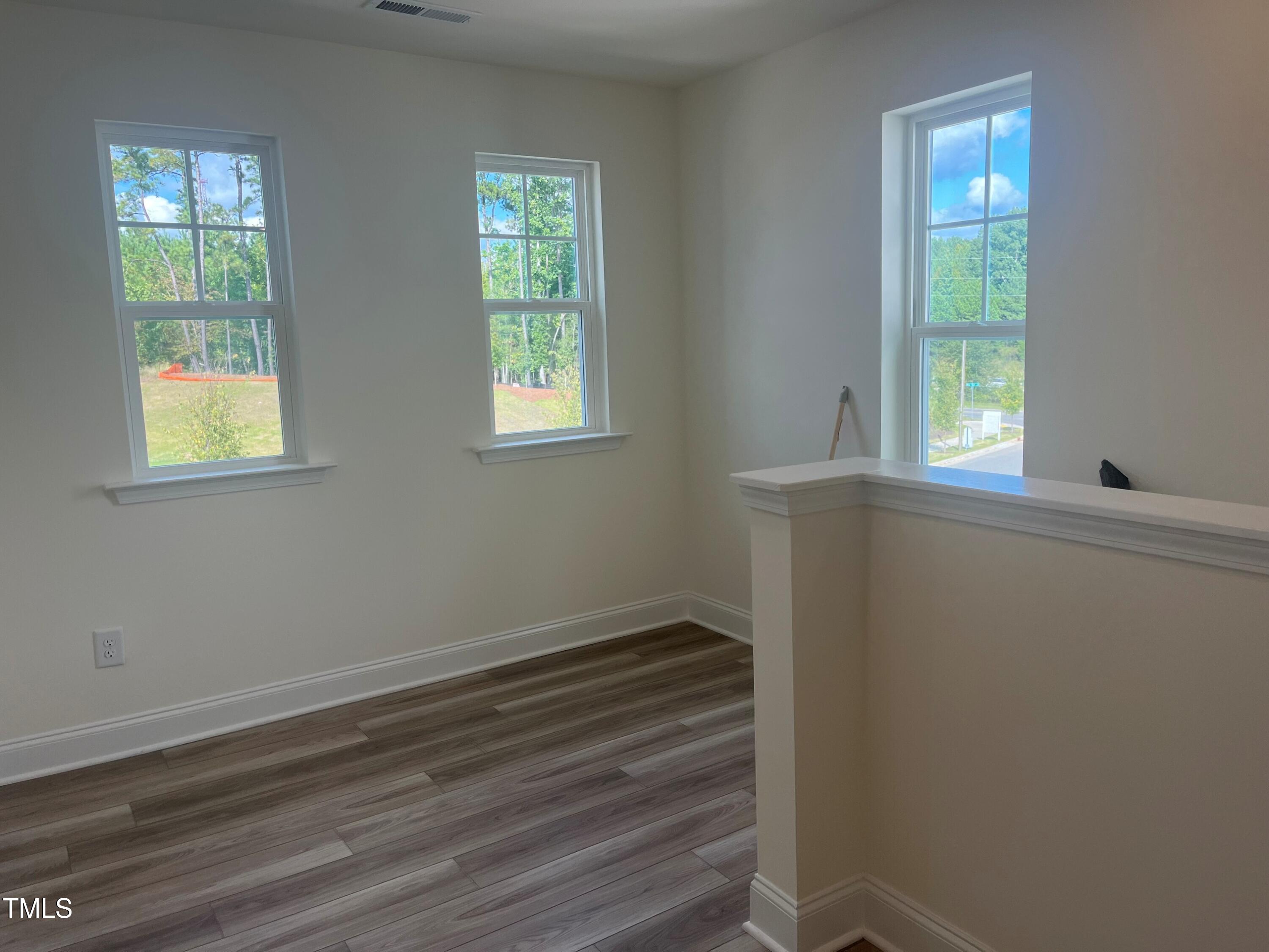 5108 River Sand Trail Raleigh, NC 27604 - Photo 27 of 59 a view of an empty room with wooden floor and a window