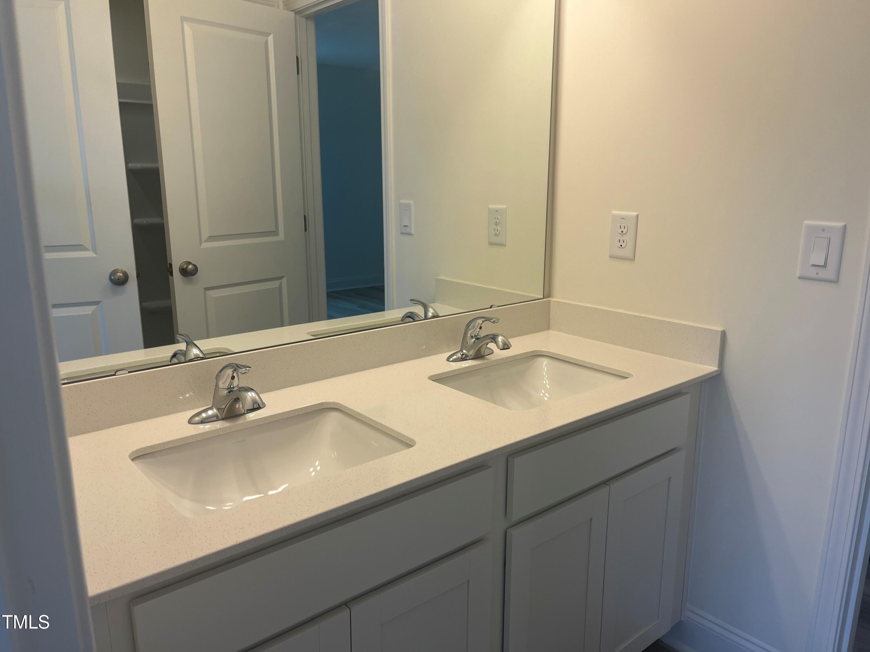 5108 River Sand Trail Raleigh, NC 27604 - Photo 35 of 59 a bathroom with a sink and a mirror