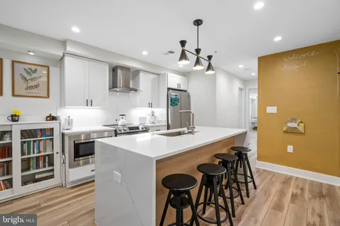 a kitchen that has a table and chairs in it