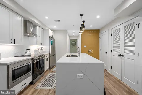 a kitchen with a stove a sink and a refrigerator