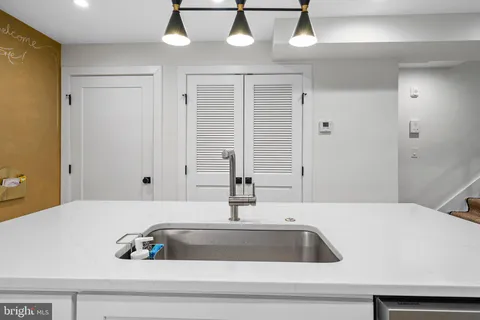 a kitchen with a sink and a mirror