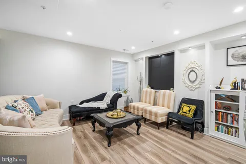 a living room with furniture and a book shelf
