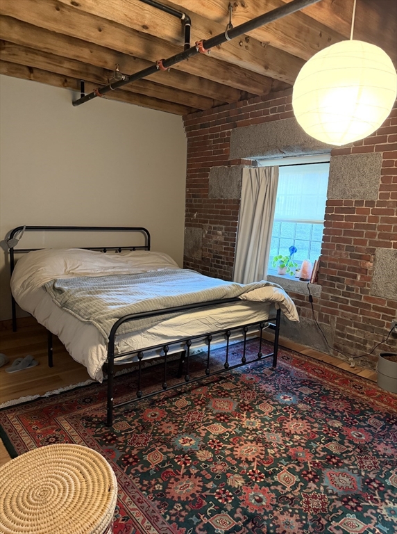 58 13th Street, Unit 112 Boston, MA 02129 - Photo 11 of 11 a bedroom with a bed and a chandelier