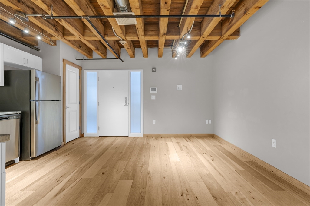 58 13th Street, Unit 112 Boston, MA 02129 - Photo 3 of 11 a view of empty room with wooden floor